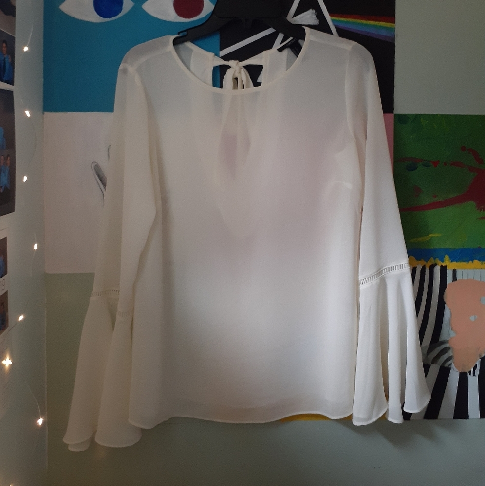 Cream-colored, flared sleeved blouse